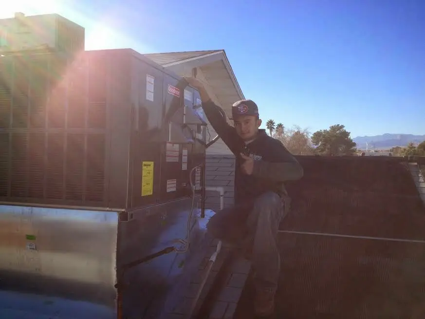 HVAC technician performing HVAC Inspection on a rooftop unit in Winston-Salem